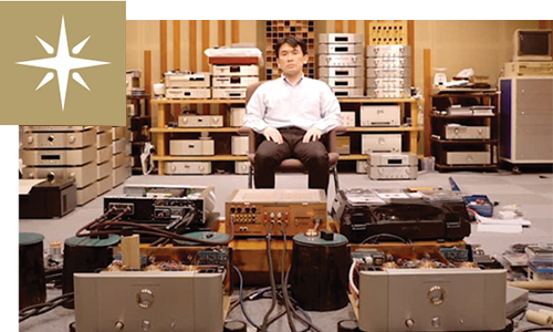 Man in room with several amplifiers and receivers